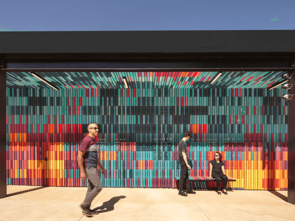 People walking past multicolored commercial building