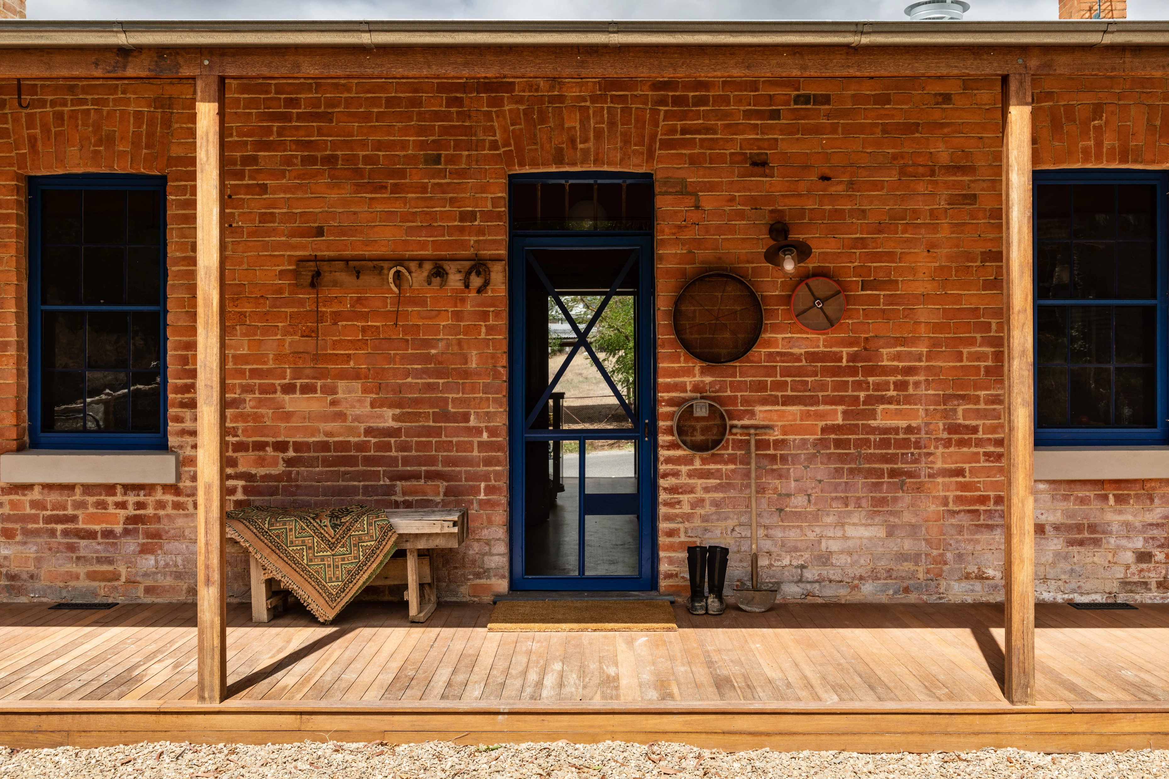 Red brick house with timber verandah posts and deck