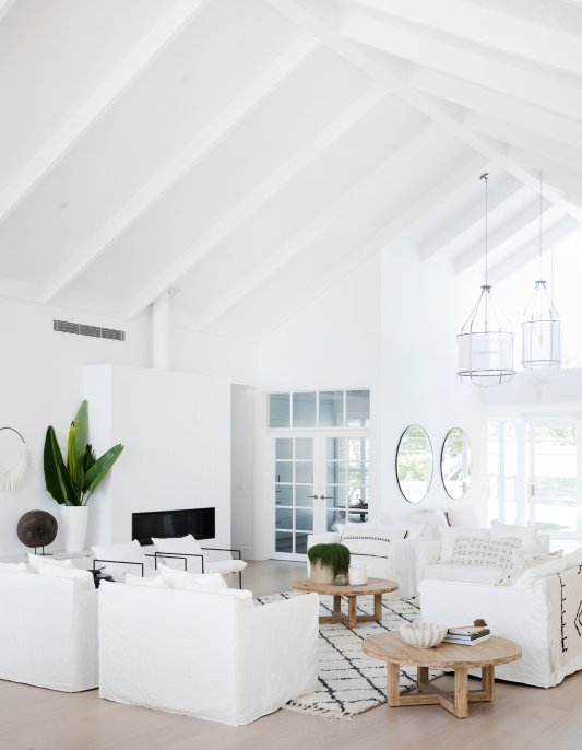 White living room with high pitched ceiling