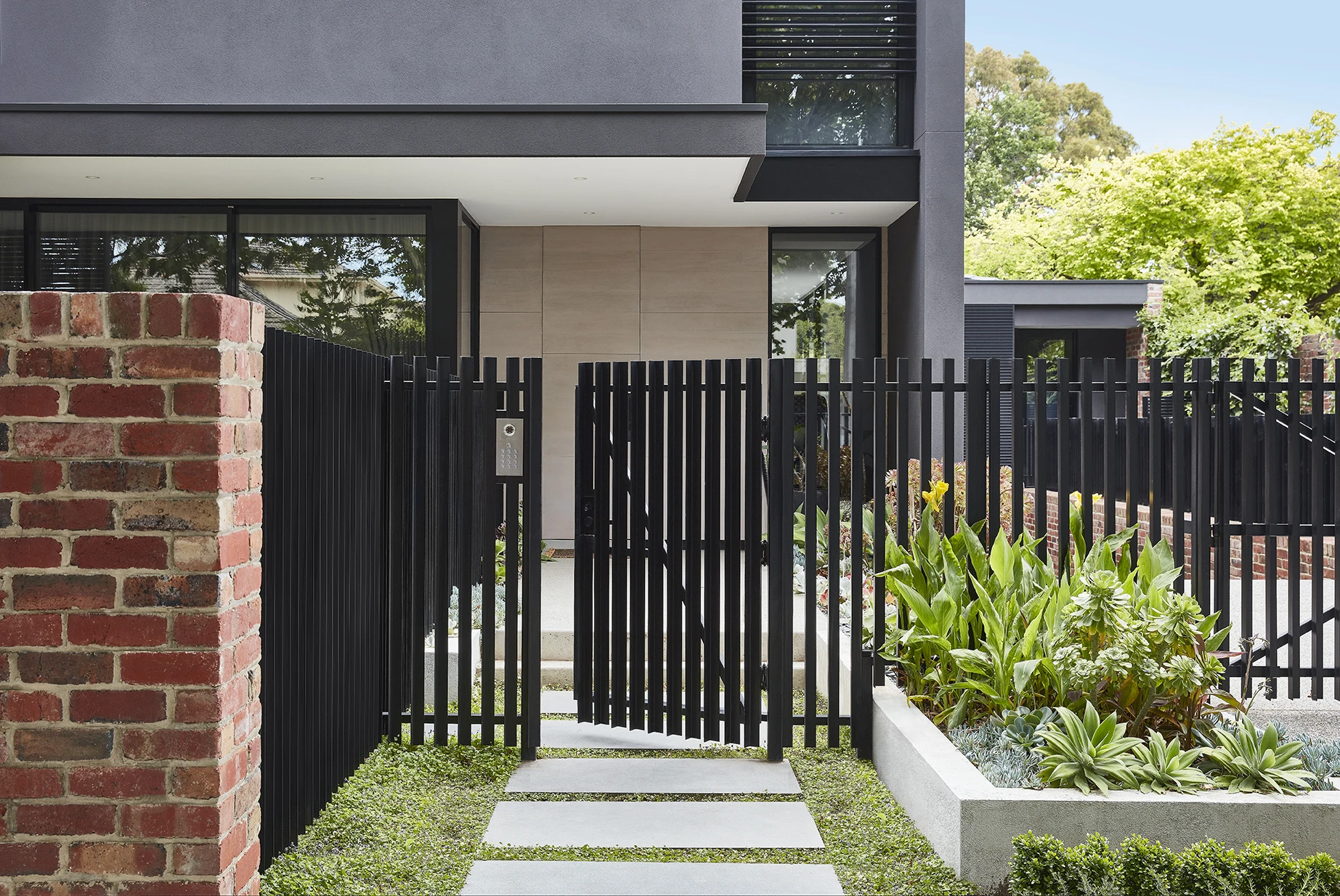exterior modern house with black metal fence and gates