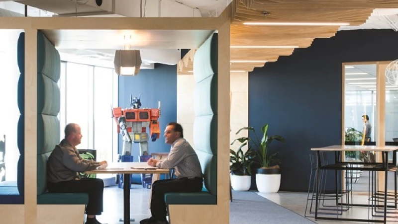 Two men sitting in a meeting nook in office