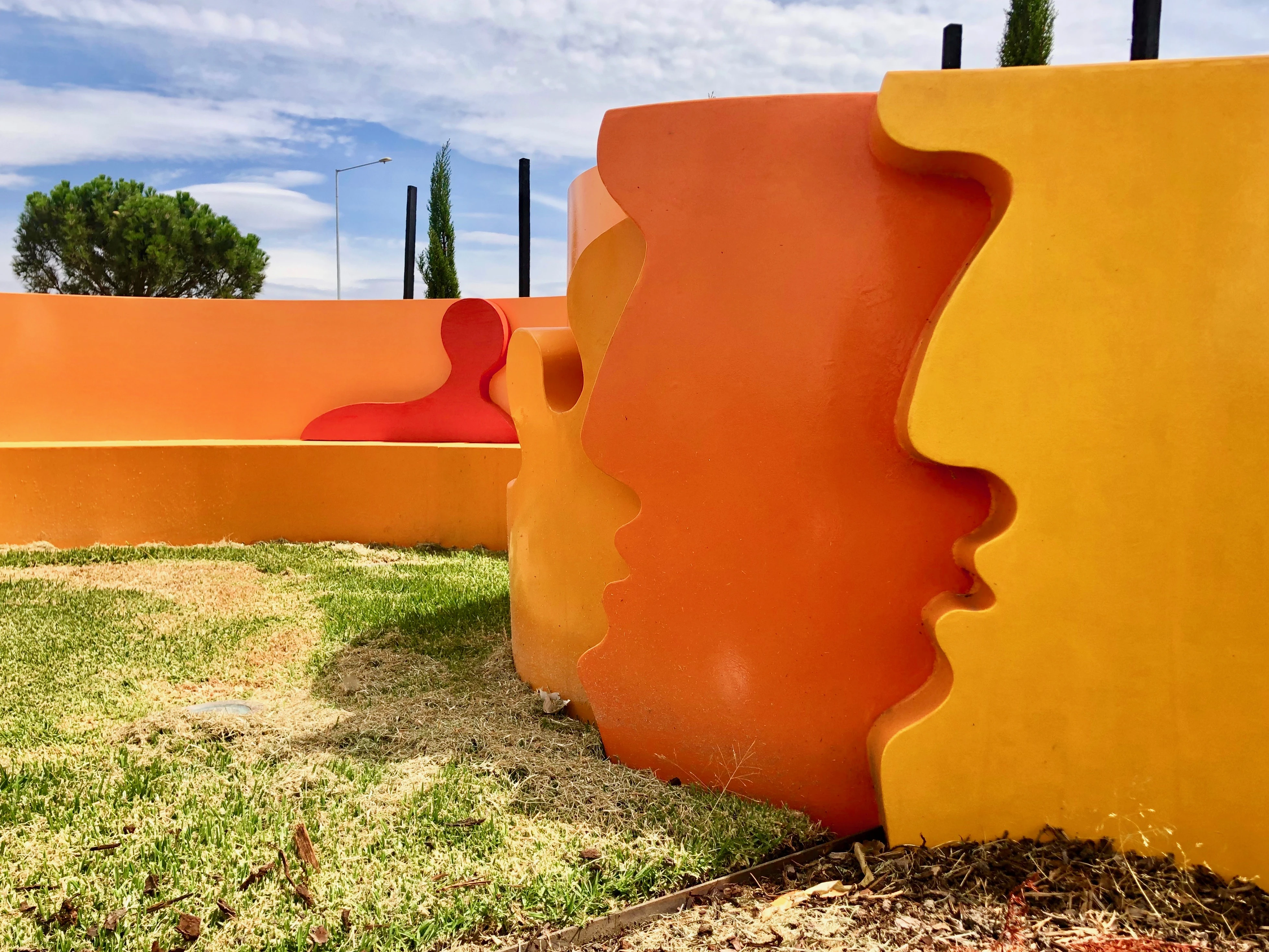 Orange metal public art in open space