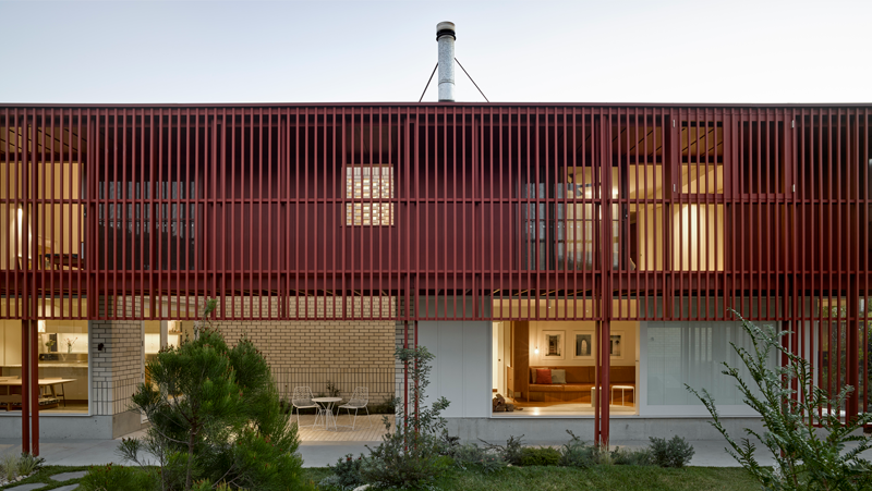 double-storey house with red louvres