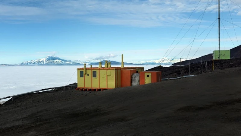 Orange and yellow hut beside Antarctic ice
