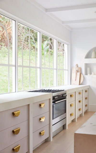 Hinterland Project, NSW. Long kitchen bench facing windows. Dulux White on White™ 