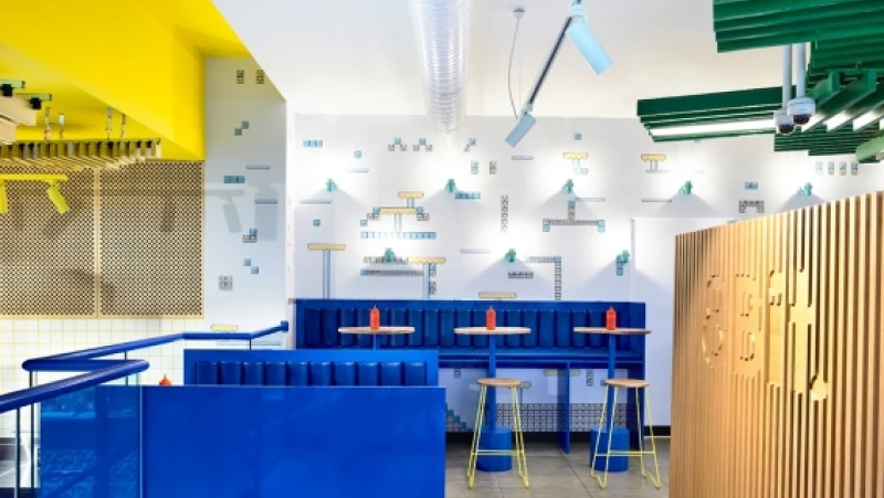 Royal blue booths and tables with white and yellow ceiling