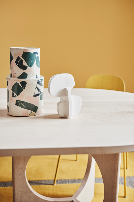 Two wooden sculptures on a wooden table