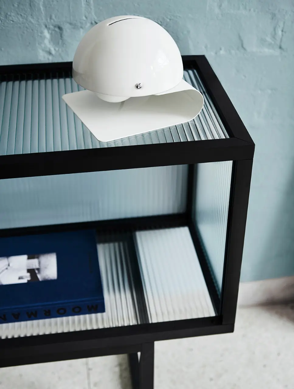 interior black and glass shelf with white sculpture. 