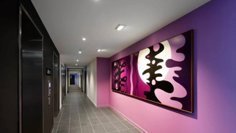 Hallway with purple feature wall and artwork