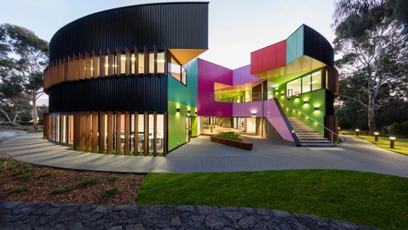 Double storey curved school building with multicoloured panels