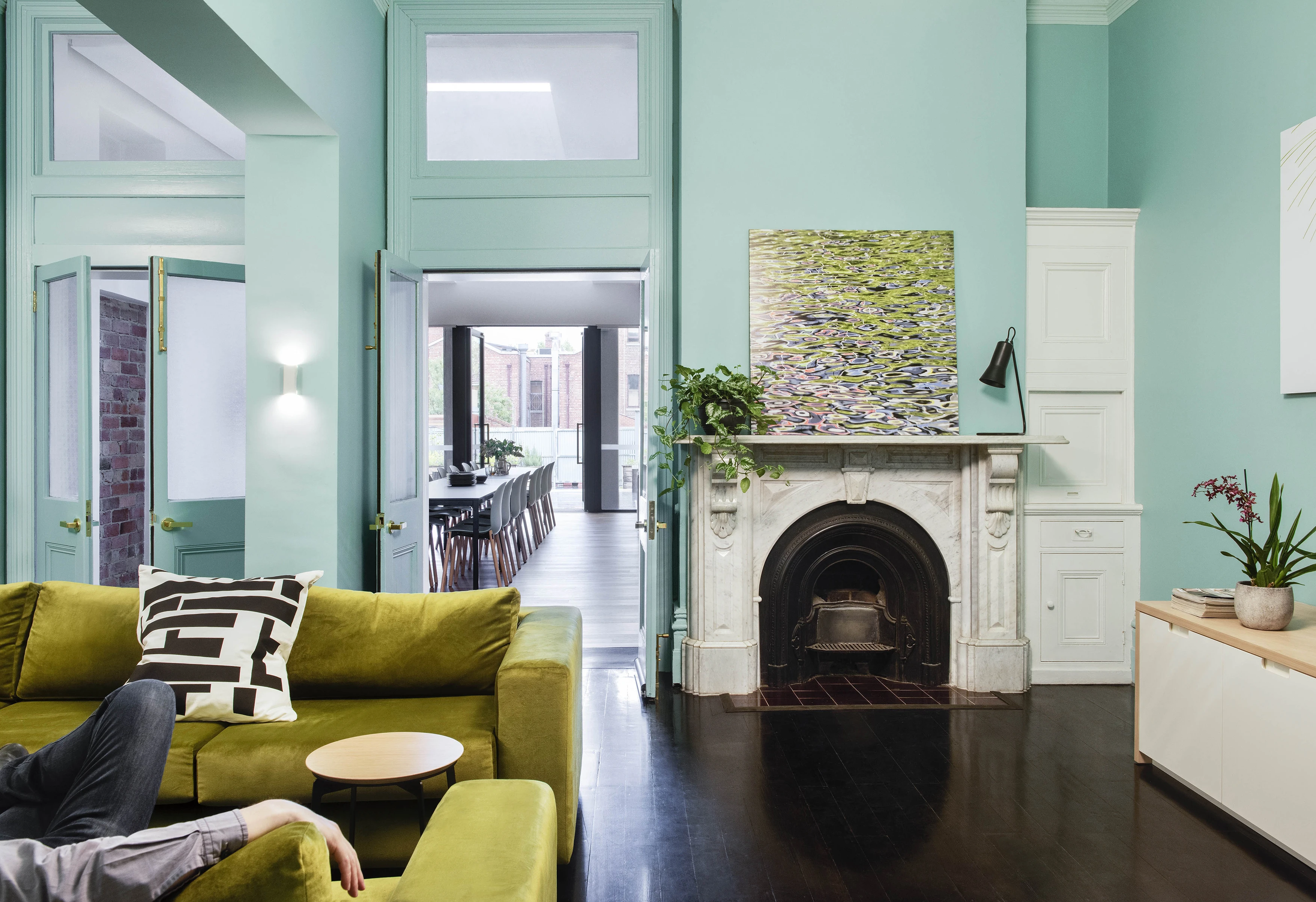 Aqua living room with traditional white mantle
