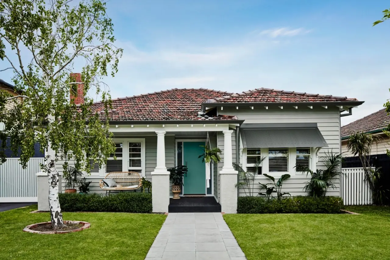 House exterior with red brick roof and green front door