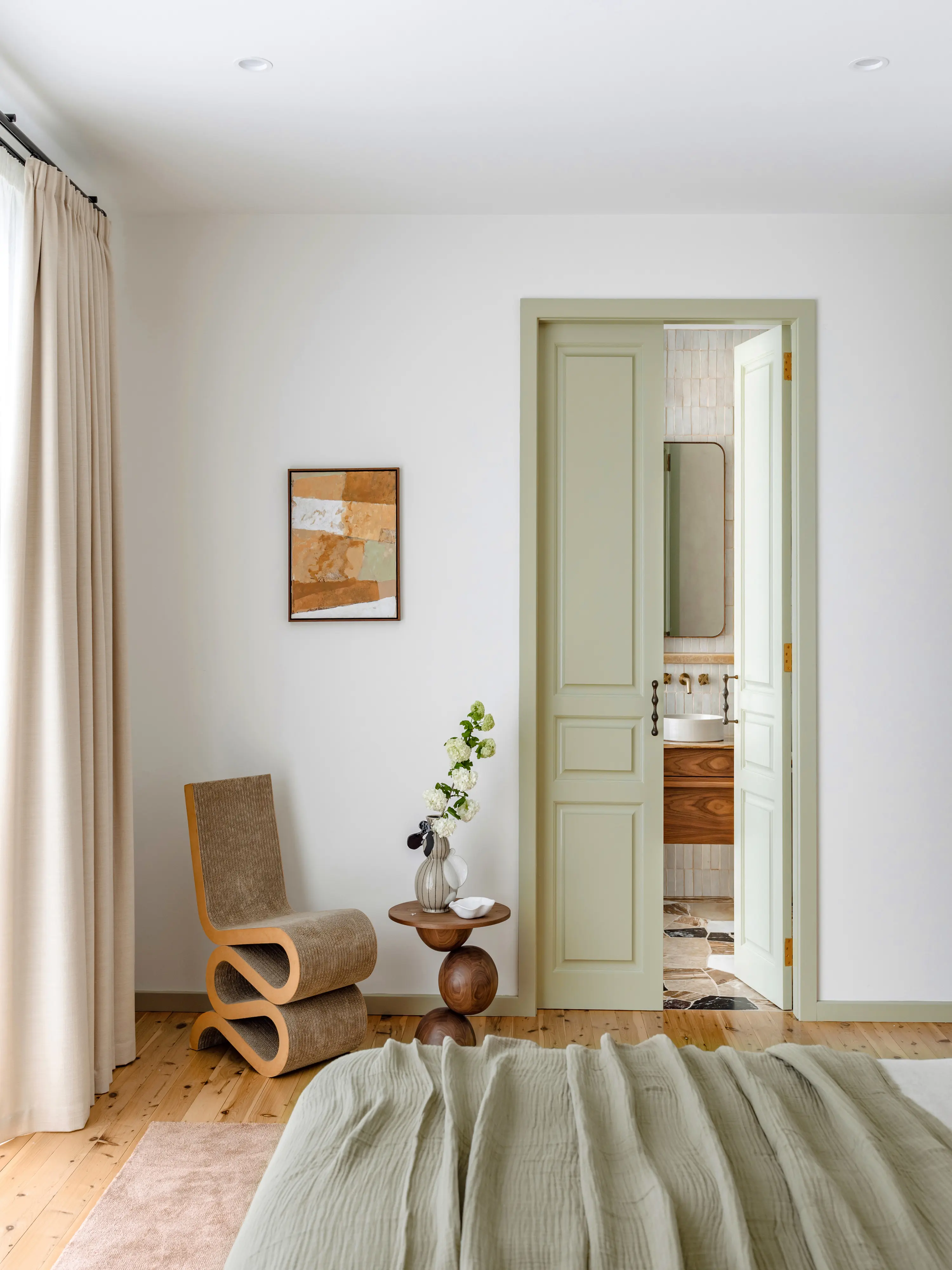 White bedroom with green door after image