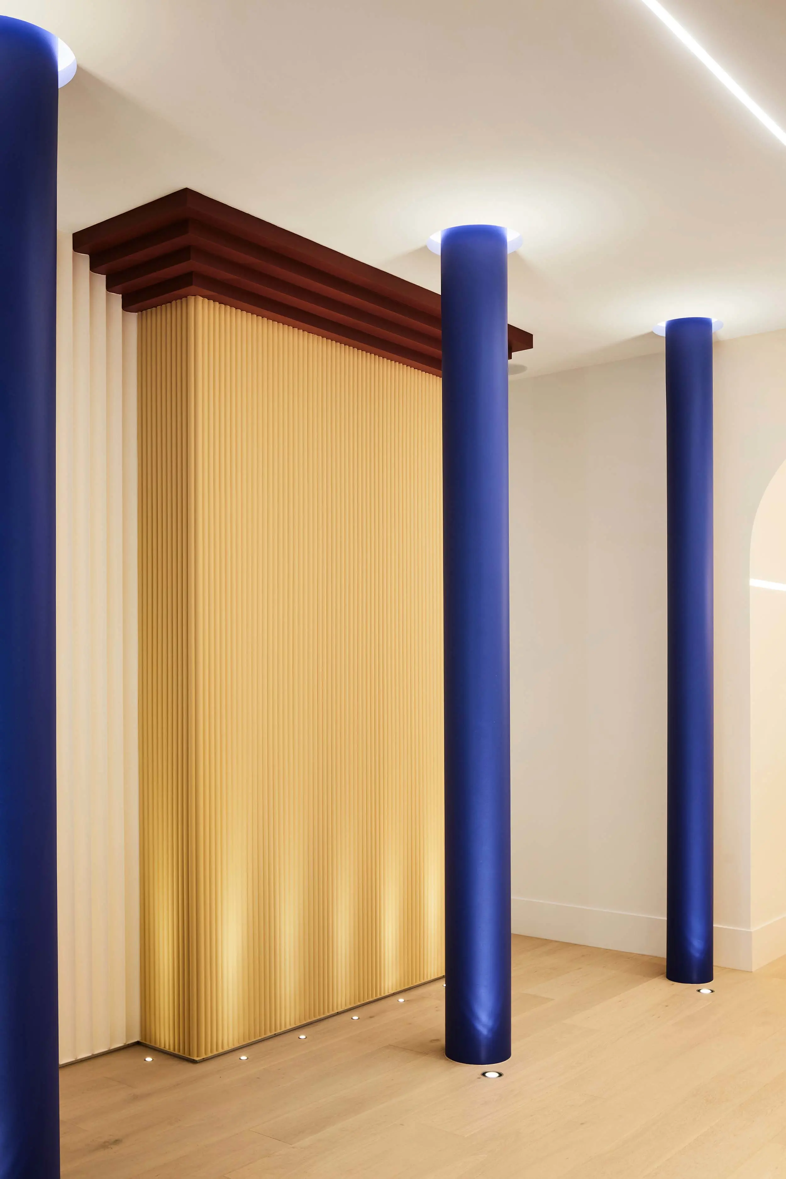 Blue columns in white and yellow showroom.