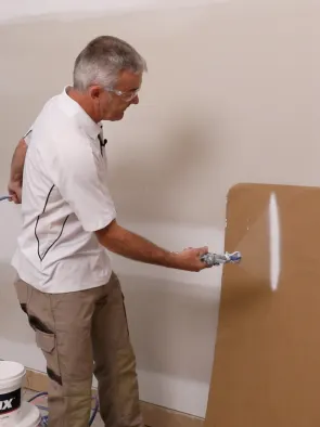 Man doing test spray with paint sprayer