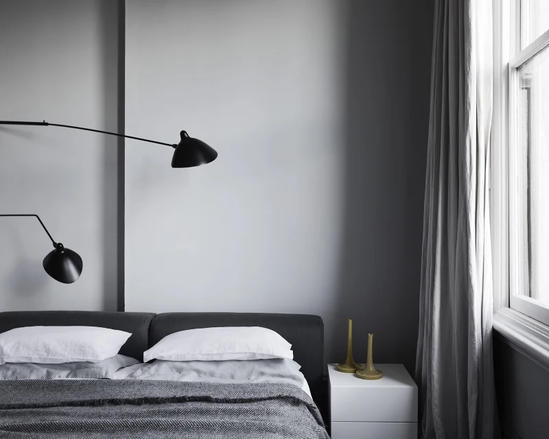 Grey bedroom with black lamps