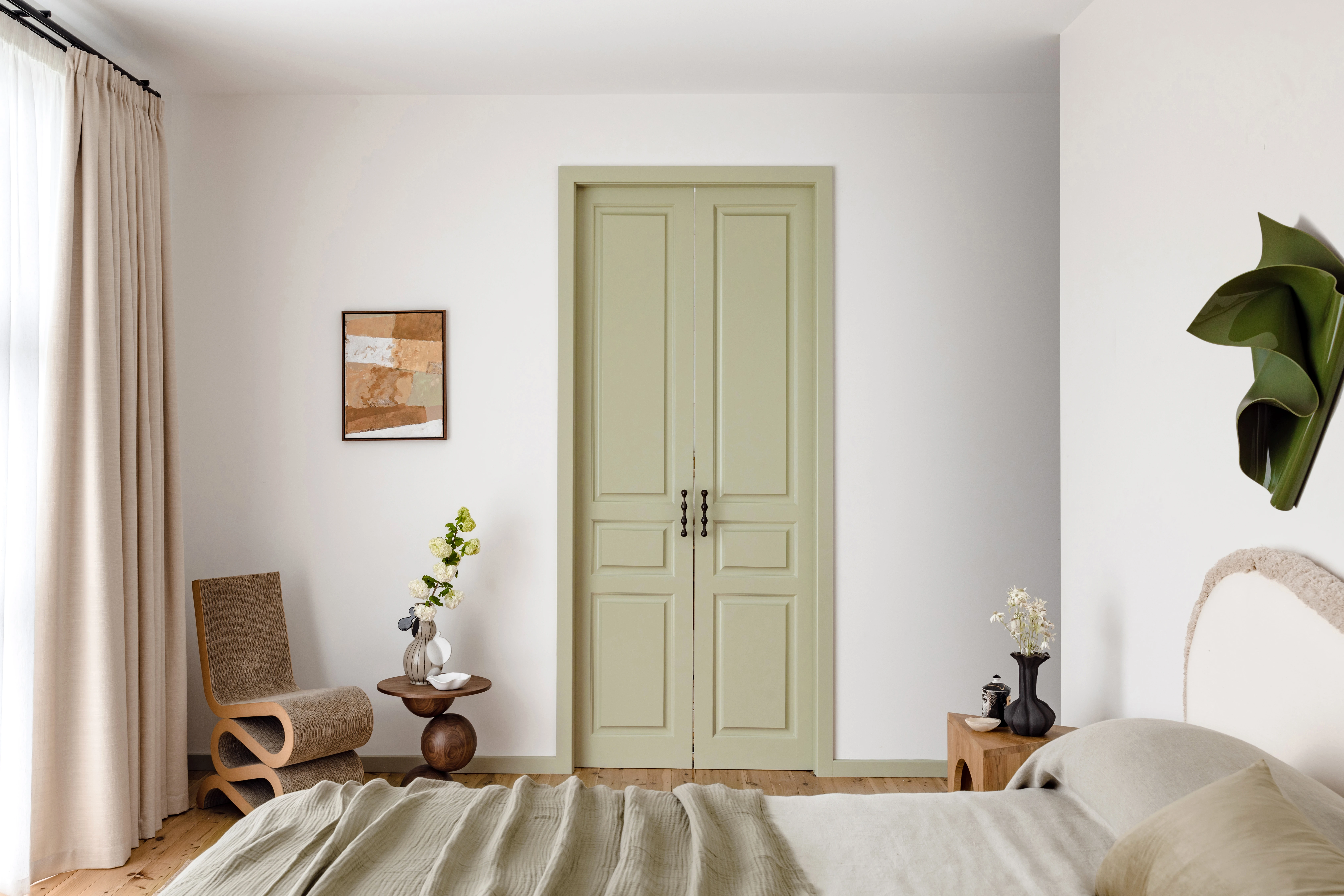 White neutral bedroom with green door