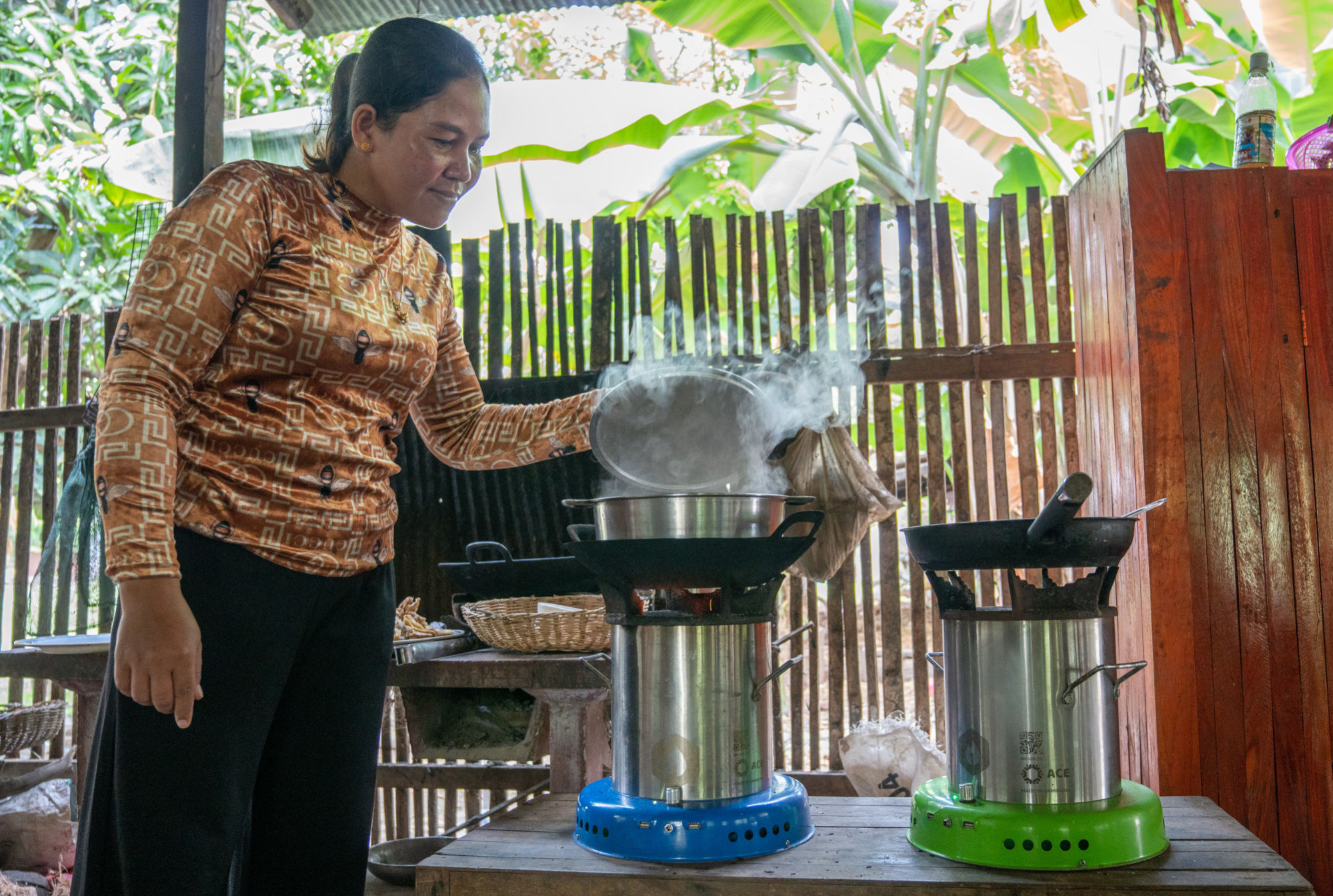 THACH USES HER CLEAN COOKSTOVE TO PREPARE DINNER FOR HER FAMILY.