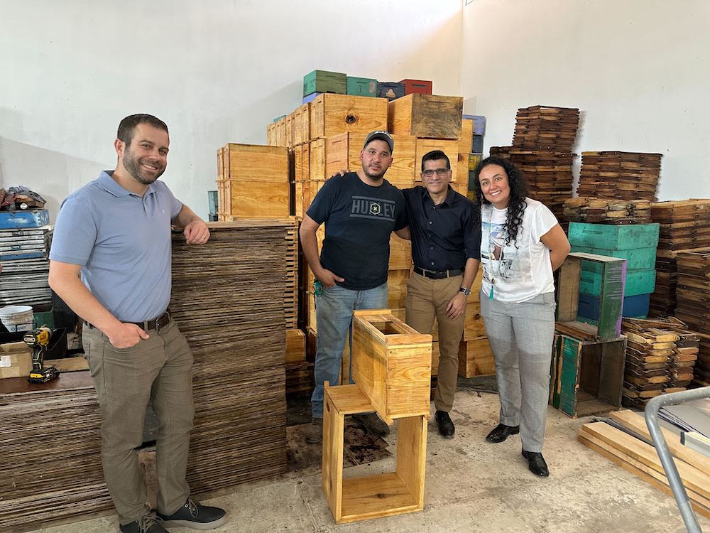 The Kiva team with Daniel at his beekeeping equipment storage facility