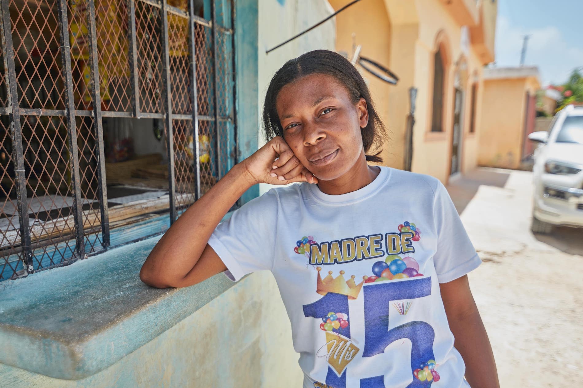 Kiva borrower Rosa outside her store and home in the Dominican Republic