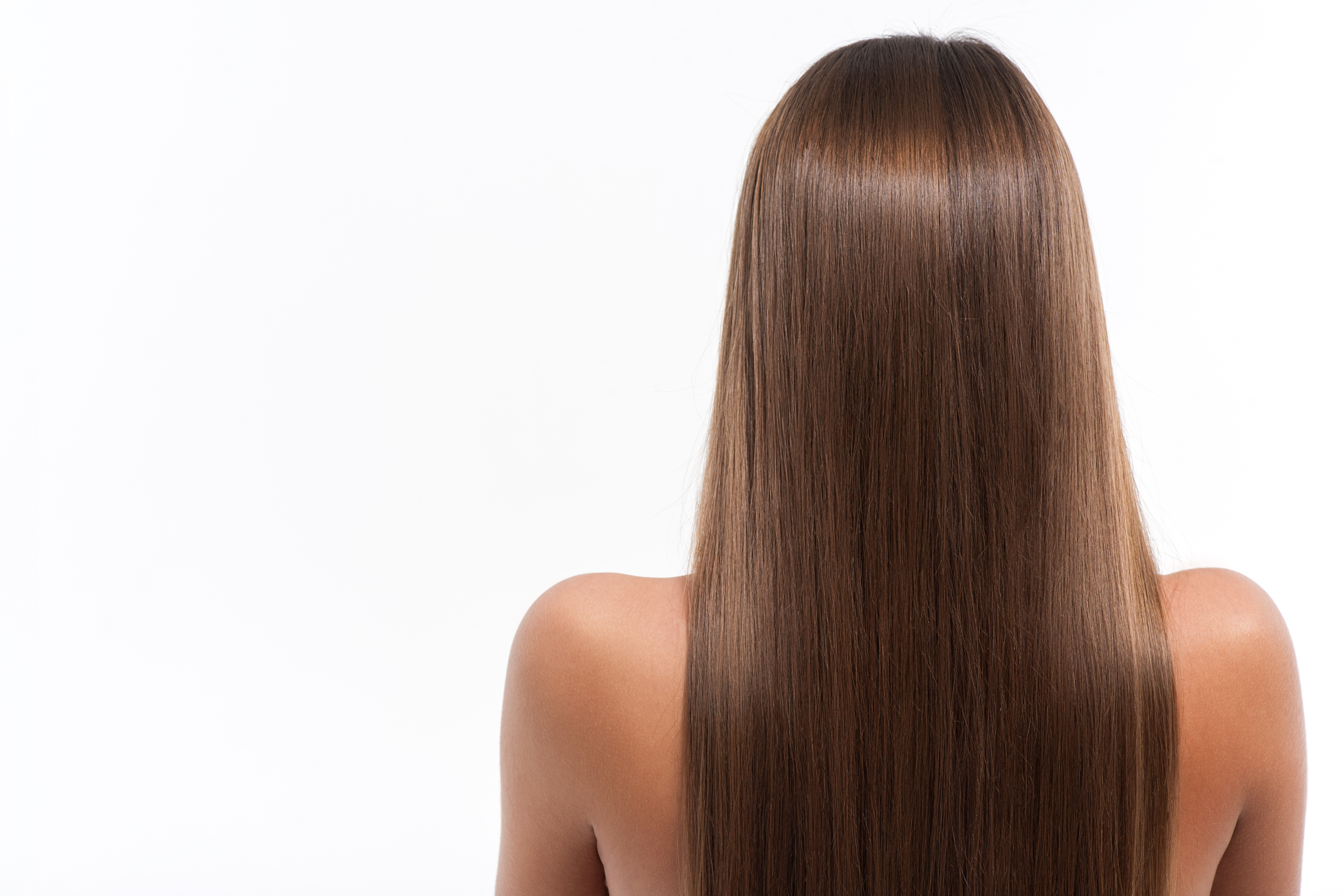 A woman's head with long brown hair shown from the back