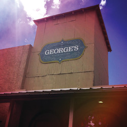 George's Distributing building with old logo on the side
