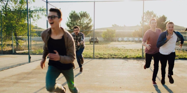 The four Box the Oxford band members running toward the frame