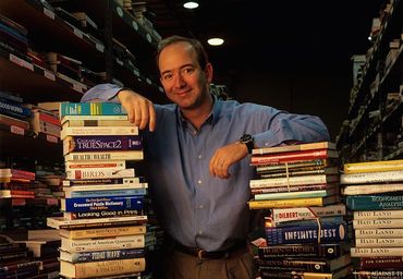 Young Jeff Bezos posing with books