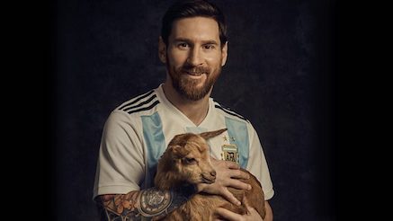 Messi holding a goat photo