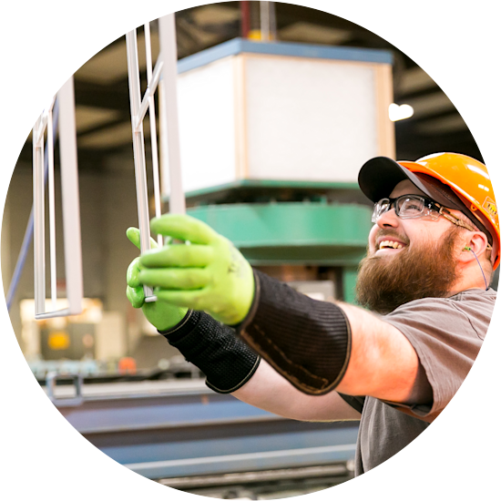 A Clayton team member handles a window frame under construction at a Clayton supply facility.