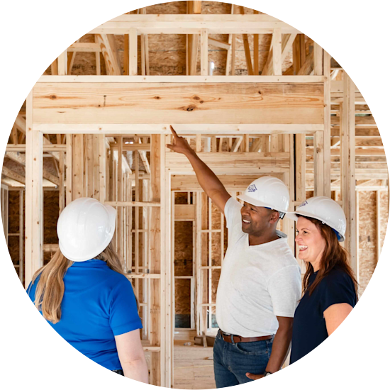 Team members in hardhats observing wall frames in a Clayton Built home
