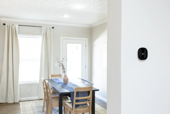 Ecobee thermostat mounted on wall next to dining room