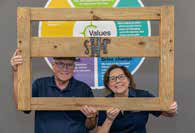 Jerry and Carolyn Murray of Sleep in Heavenly Peace proudly display a headboard the Clayton Addison II team branded with the organization’s logo.