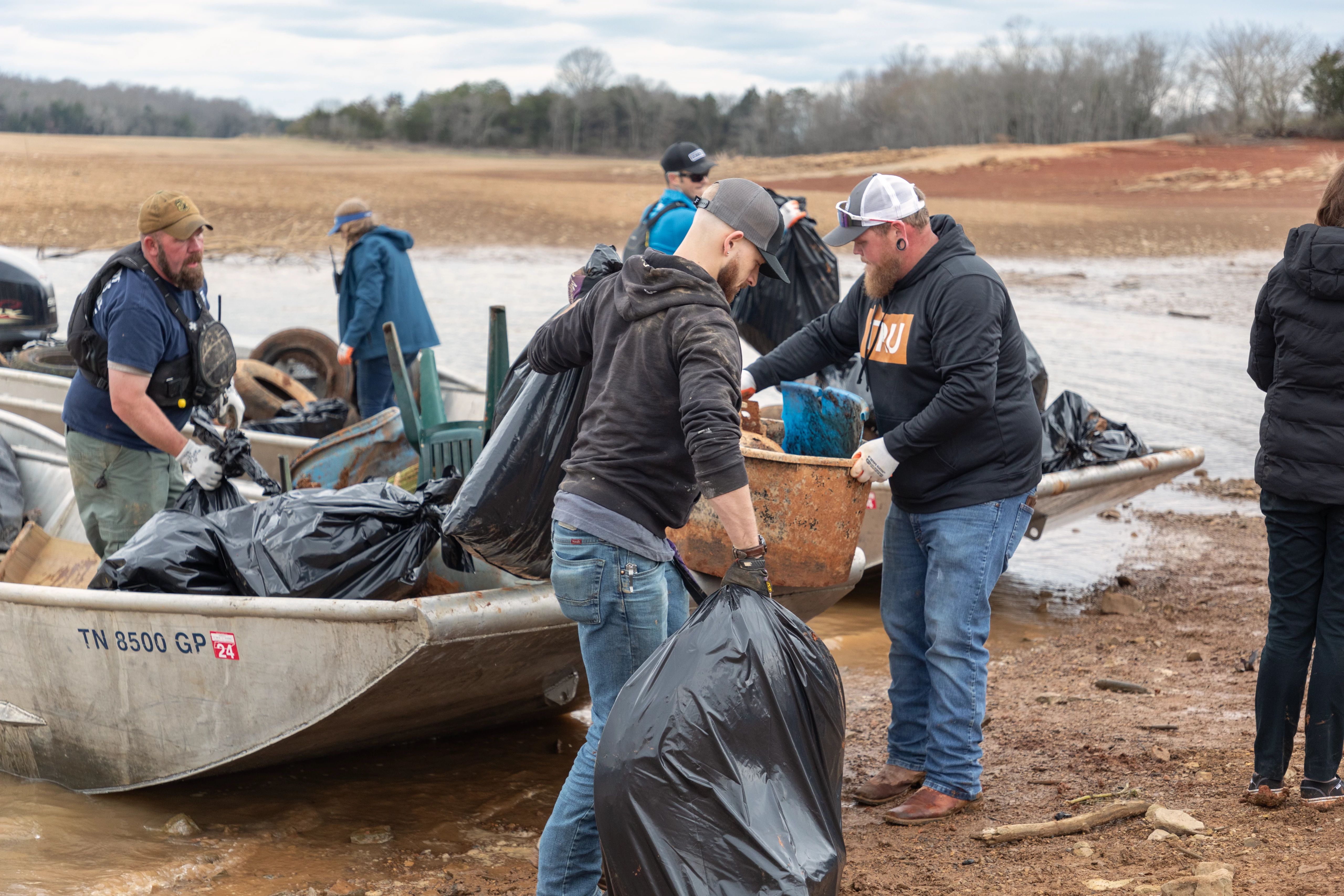 Team members collect river trash and debris