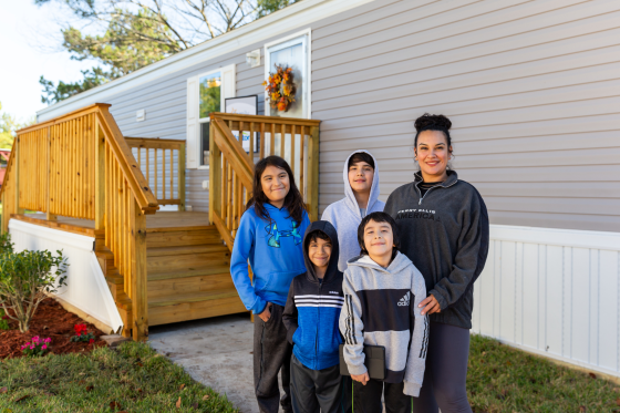 CHBG - Marroquin family standing in front of Family Promise Clayton Built home