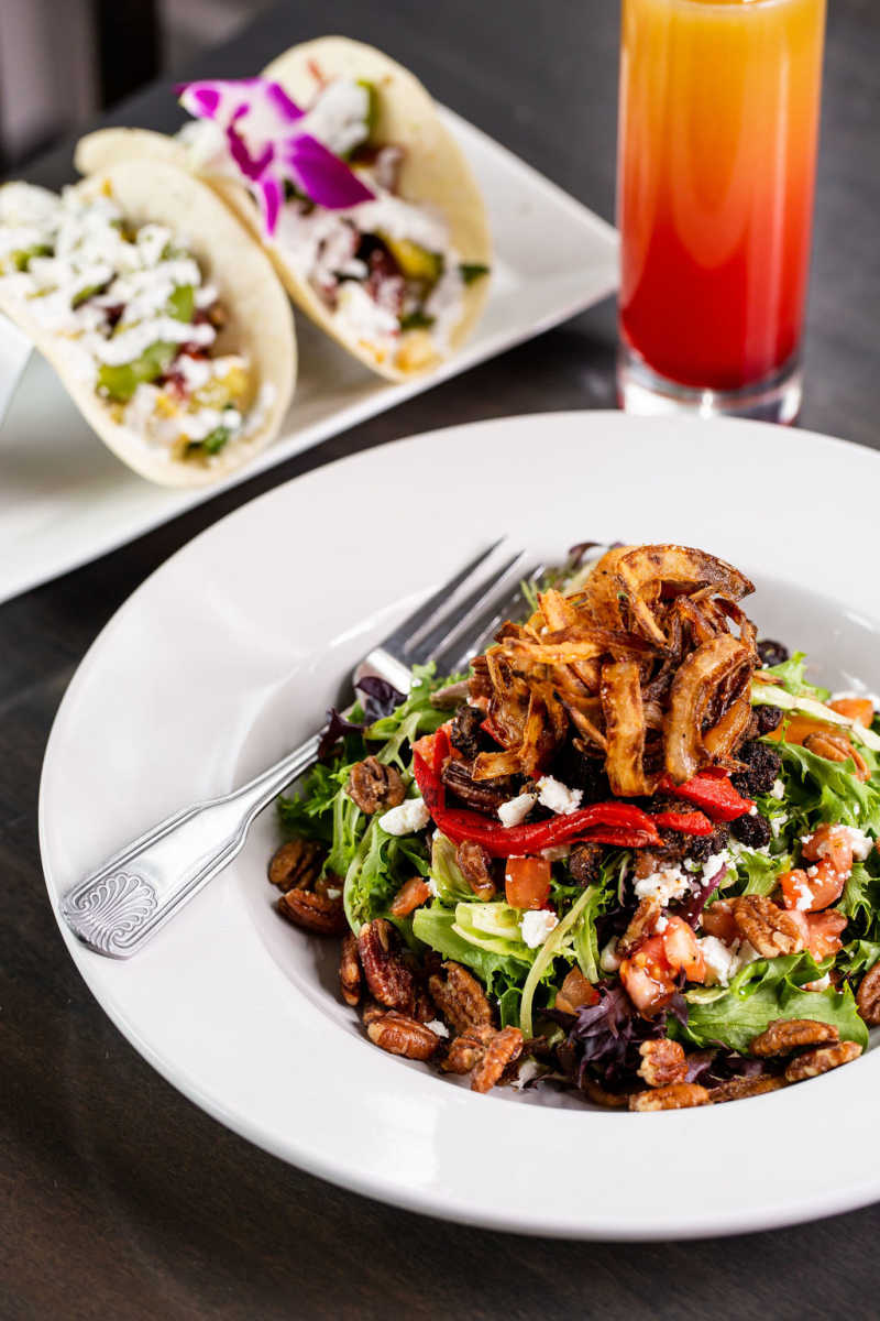 Azalea Kitchen's Blacksmith Steak Salad: Mixed greens, blackened steak tips, goat cheese crumbles, roasted red peppers, tomato, candy pecans, and crispy fried onions.