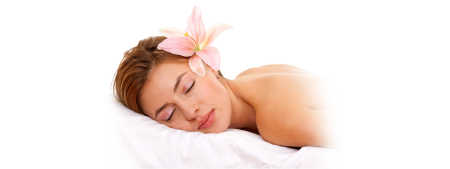 A relaxed woman lays face down on a massage table.