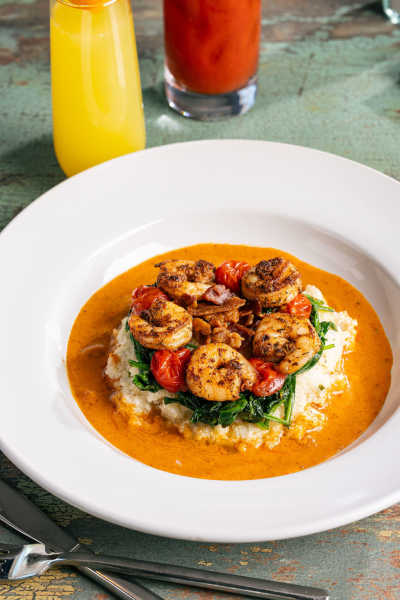 A bowl of sweet and savory shrimp and grits.