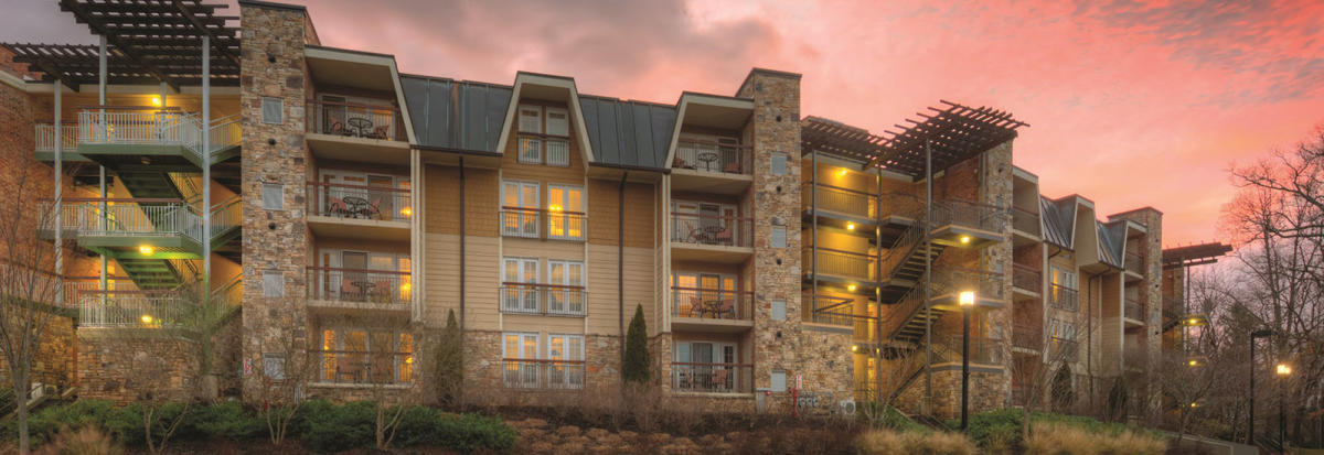A vibrant pink sunset is visible over The Residences at Biltmore.
