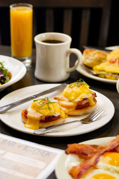 Eggs Benedict with coffee and fresh orange juice from Azalea Bar & Kitchen.