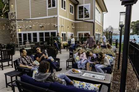 Guests enjoying time on the patio near dusk at Azalea Bar & Kitchen.