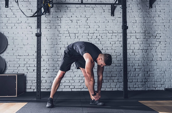 Man stretching in gym