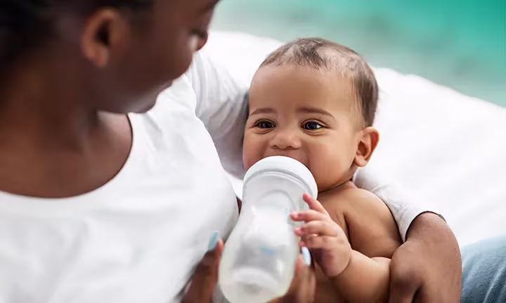 Banner image of when do babies hold their own bottle