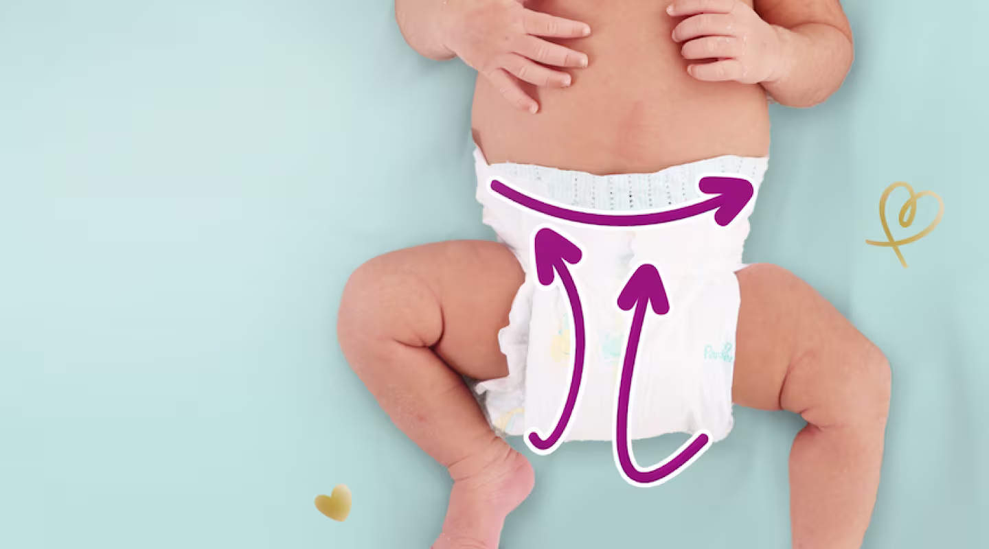 Baby from the chest down in a Pampers Active Baby diaper