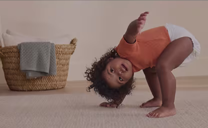 Walking toddler in a Pampers diaper with adaptive fit design