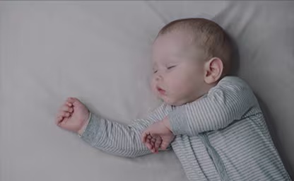 Newborn baby lying comfortably in a Pampers diaper