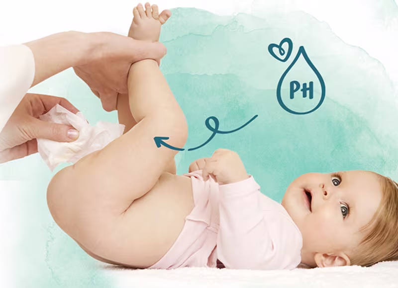 Baby being gently wiped with Pampers wipes — pH balanced formula that protects baby's delicate skin