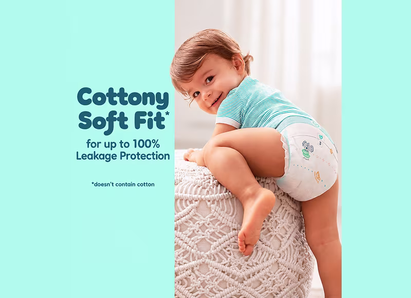 Active toddler climbing on furniture wearing Pampers Pants — cottony soft fit for up to 100% leakage protection Active toddler climbing on furniture wearing Pampers Pants — cottony soft fit for up to 100% leakage protection