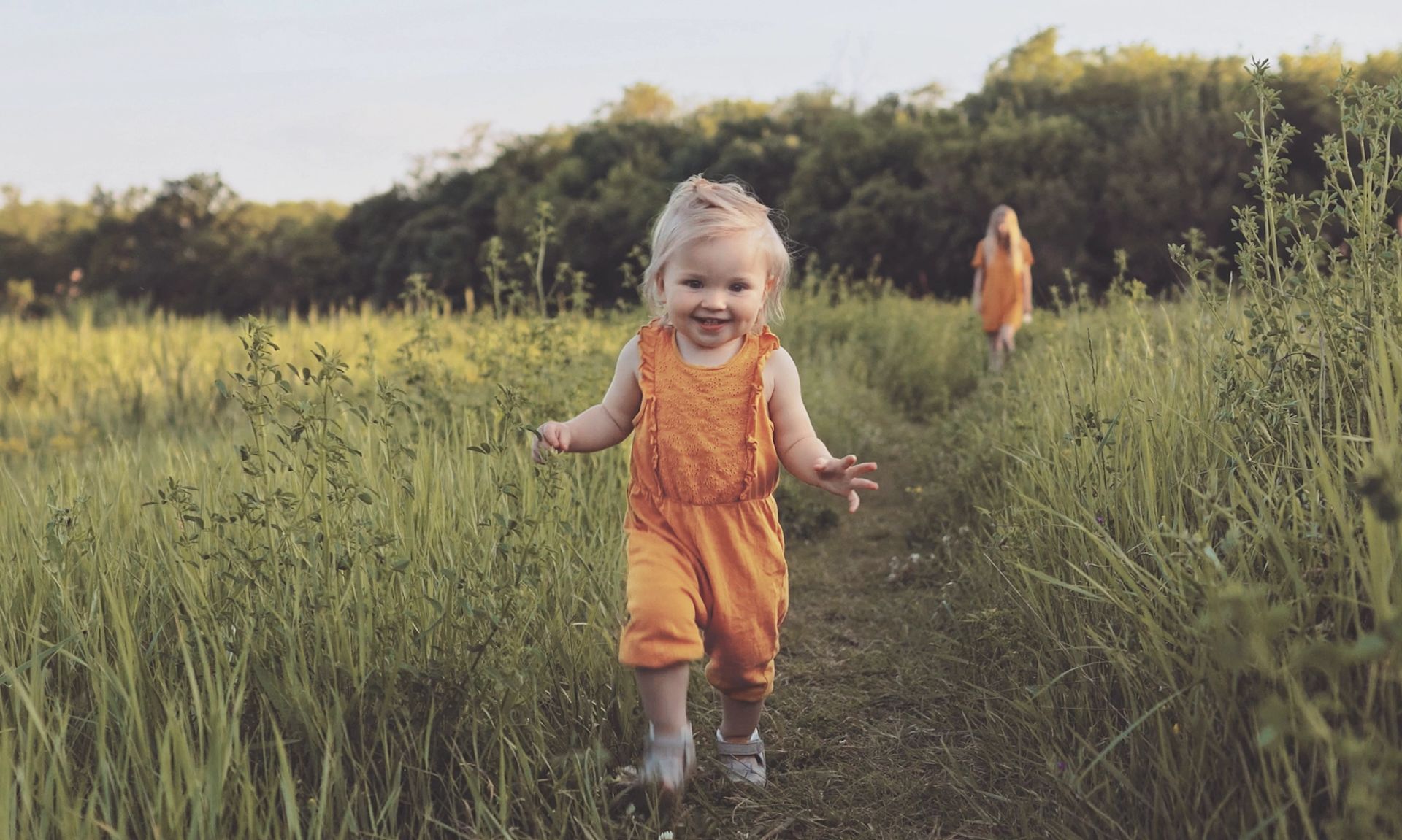 A little girl walks in nature - highlighting a healthy baby on a healthy planet.