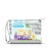 A clear pouch contains baby care products, including lotion, soap, shampoo, and a purple bottle, resting on a white surface. Text: "Johnson's Tiny Traveler Baby Gift Set."